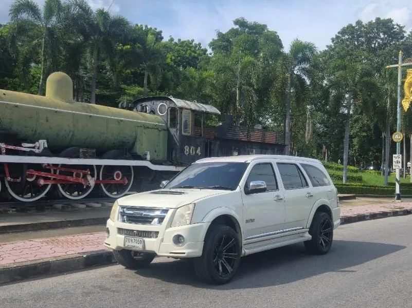 White SUV beside the Death Railway locomotive in Kanchanaburi