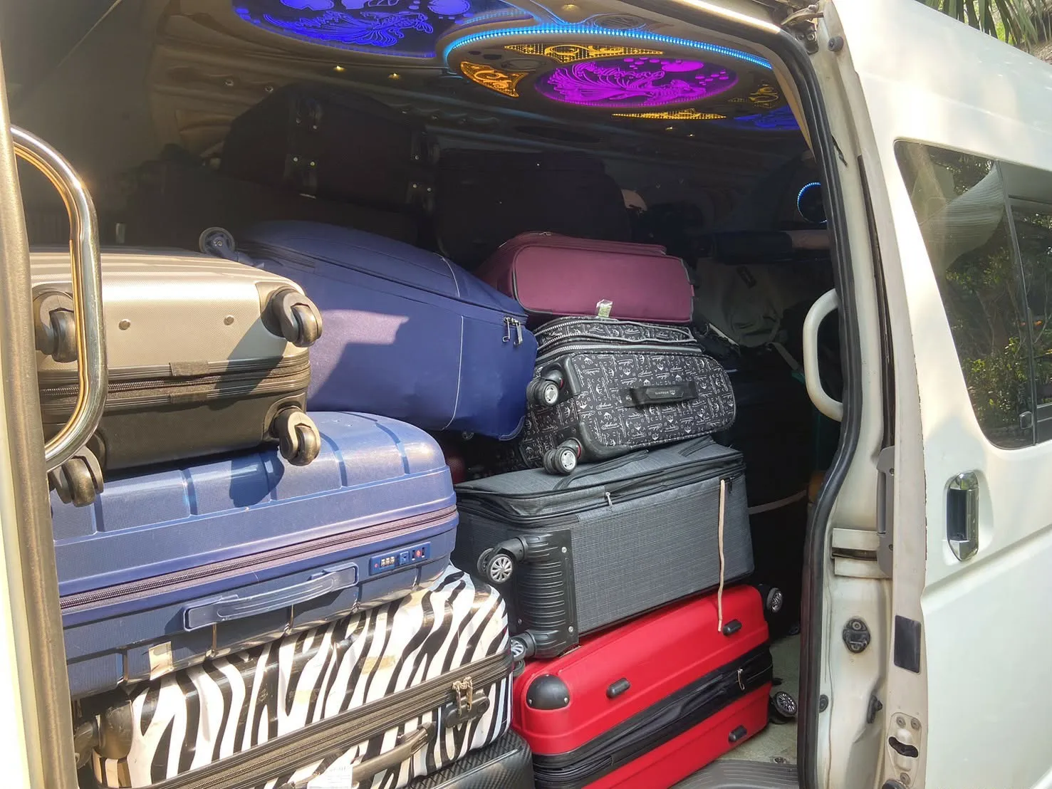 Suitcases stacked neatly inside the van